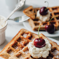 Waffles with whipped cream and cherry