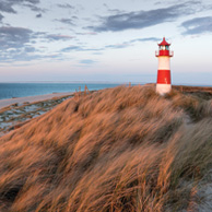 Landscape with sand dunes and a lighthouse