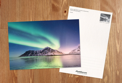 Northern light above mountains and sea shore