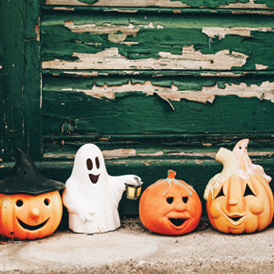 Little ghost and smiling pumpkins