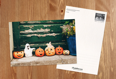 Little ghost and smiling pumpkins